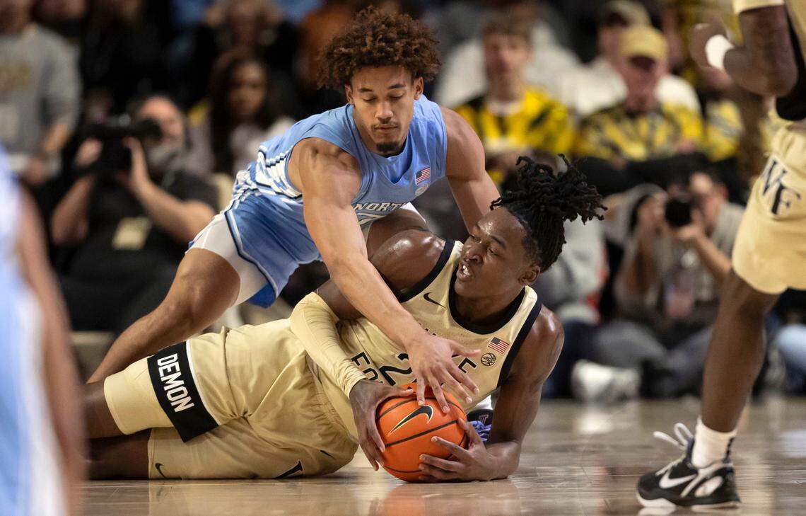 Wake Forest’s Tre’Von Spillers (25) secures a loose ball beneath North Carolina guard Seth Trimble (7) in the first half on Tuesday, January 21, 2025 at Lawrence Joel Coliseum in Winston-Salem, N.C.