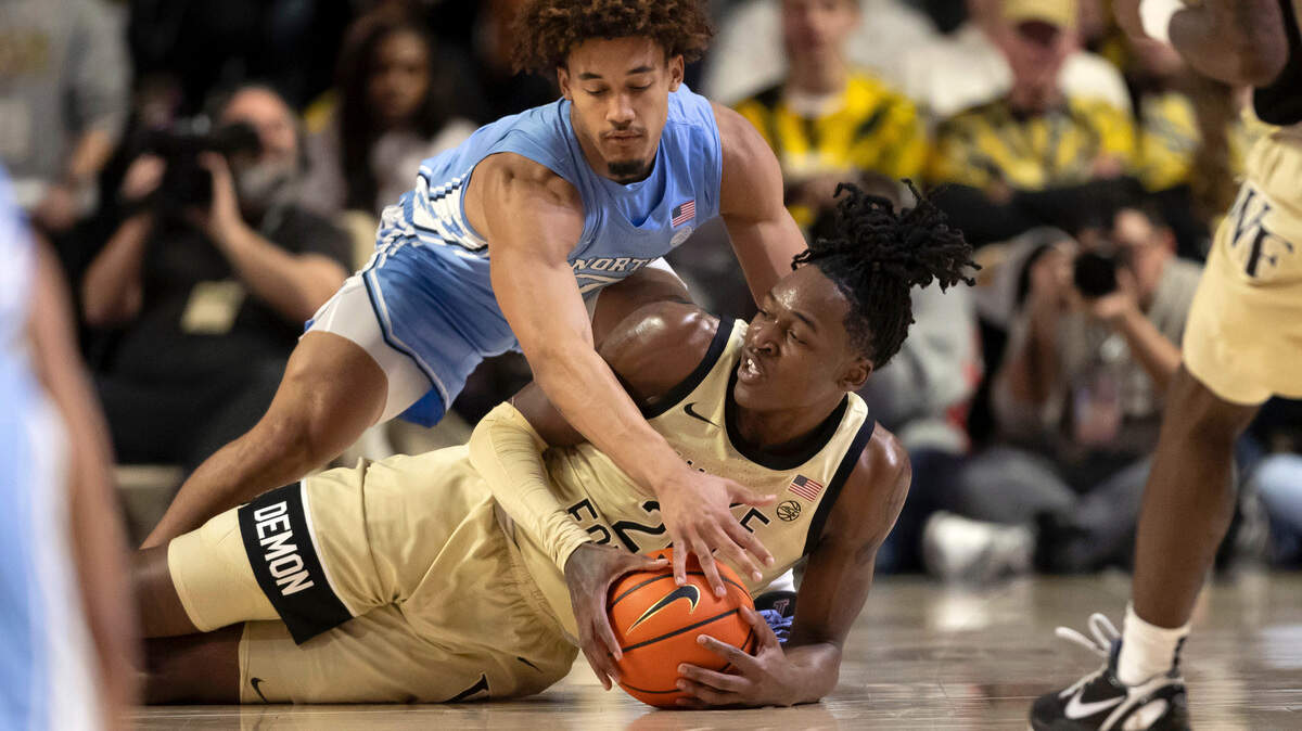 Wake Forest’s Tre’Von Spillers (25) secures a loose ball beneath North Carolina guard Seth Trimble (7) in the first half on Tuesday, January 21, 2025 at Lawrence Joel Coliseum in Winston-Salem, N.C.