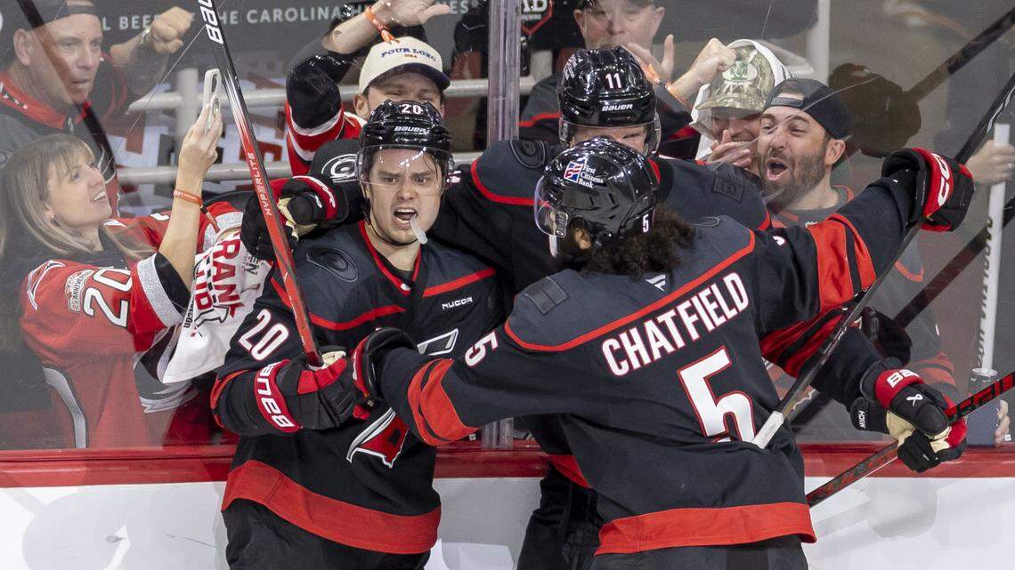 Carolina Hurricanes center Sebastian Aho (20) celebrates with teammates Jordan Staal (11) and Jalen Chatfield (5) after scoring to take a 2-0 lead against Ottawa in the second period of Game 2 on Monday, April 20, 2026 during the first round of the Stanley Cup Playoffs at Lenovo Center in Raleigh, N.C. 