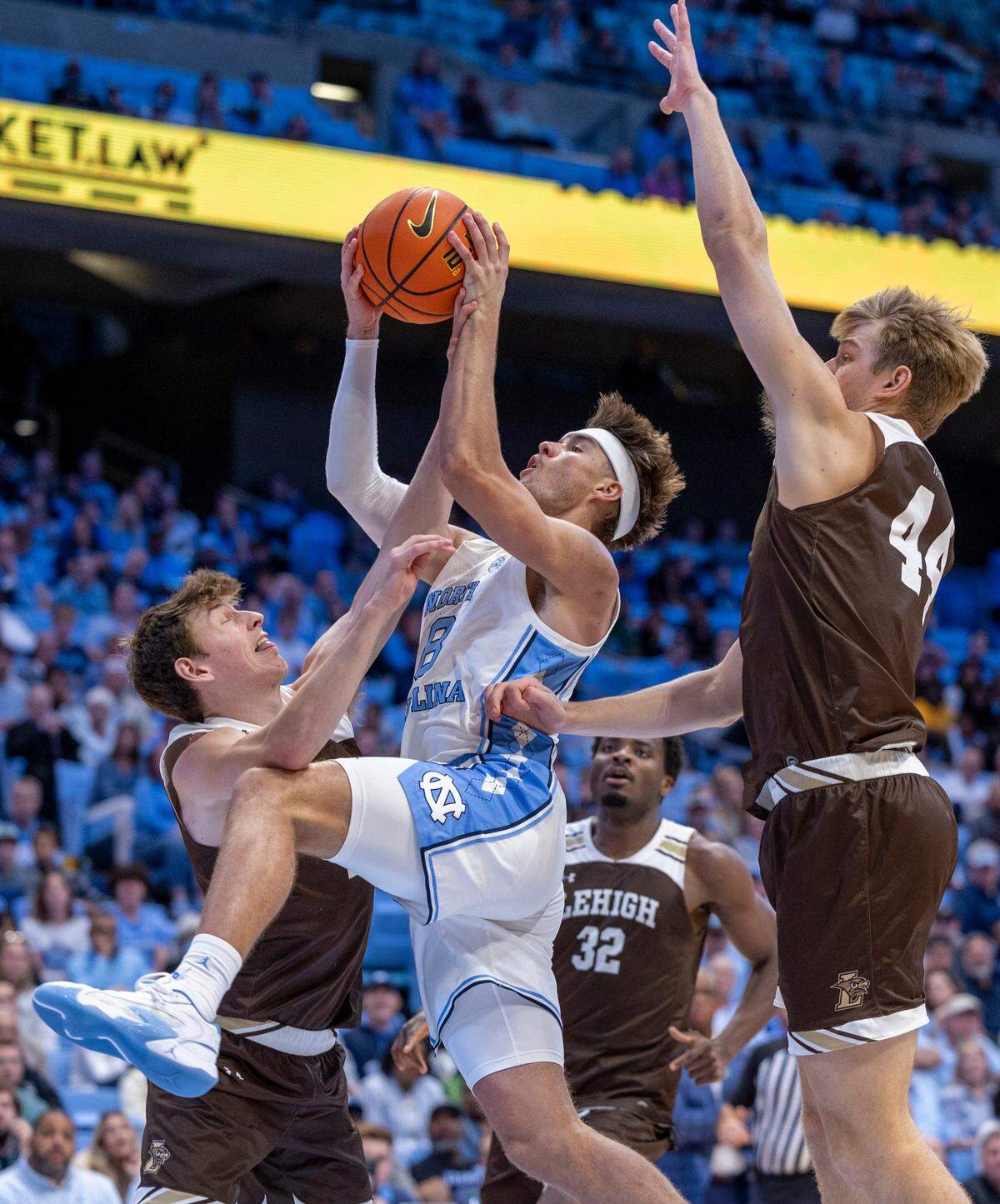 North Carolina’s Paxson Wojcik (8) drives to the basket against Lehigh’s Ben Knostman (2) and Joshua Ingram (4) in the second half on Sunday, November 12, 2023 at the Smith Center in Chapel Hill, N.C.
