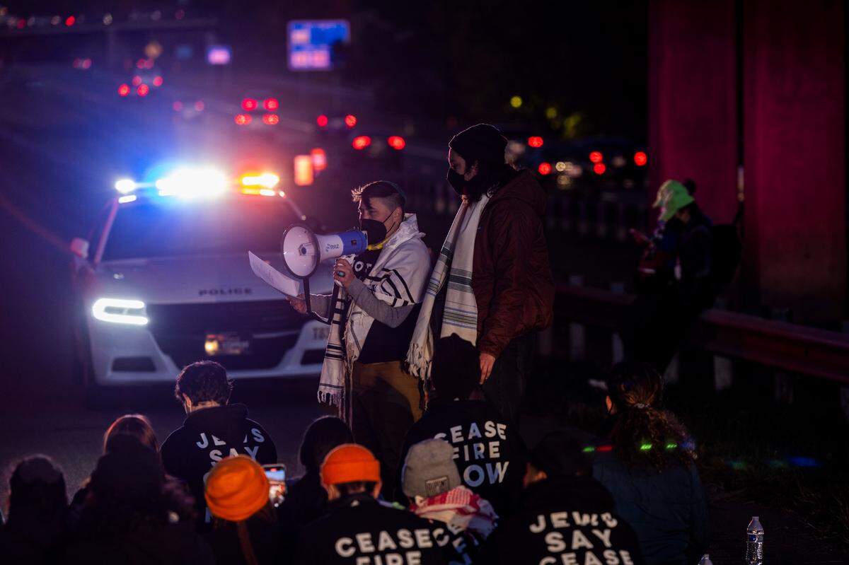 Protesters sing and pray while blocking the northbound lanes of the Durham Freeway at the South Magnum Street bridge for hours Thursday evening, Nov. 2, 2023. The demonstrators were demanding a ceasefire in the Israel-Gaza War as police warned of arrests.