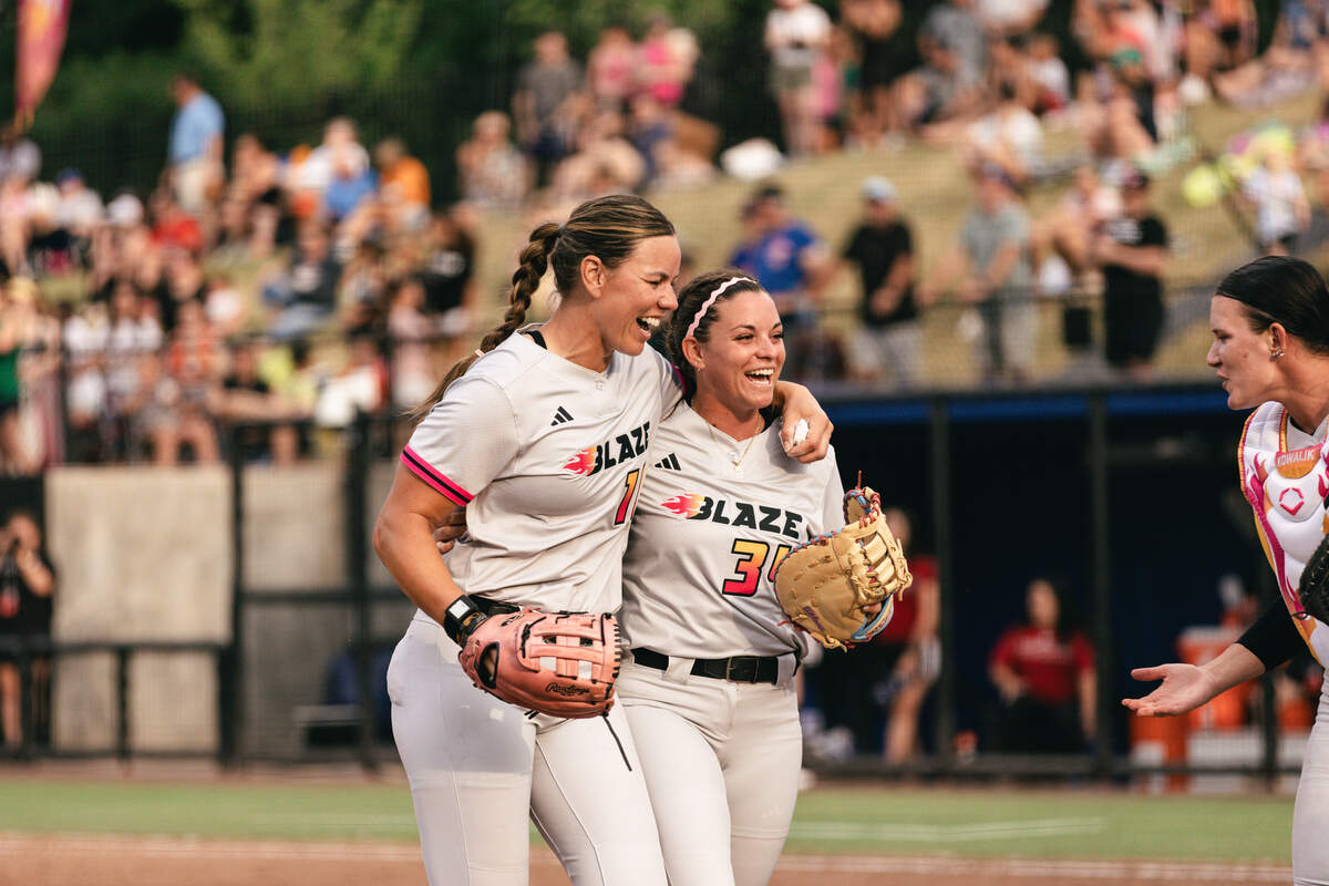 Carolina Blaze pitcher Keilani Ricketts (10) and utility player Devyn Netz (34) walk off the field during a game at Smith Family Stadium in Durham, North Carolina.