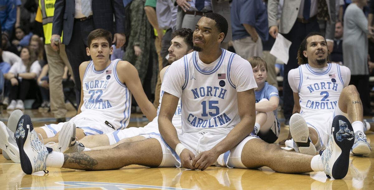 North Carolina’s Garrison Brooks (15) and his teammates watch senior Shea Rush (11) as he makes his senior night remarks following the Tar Heels’ win over Wake Forest on Tuesday, March 3, 2020 in Chapel Hill, N.C.