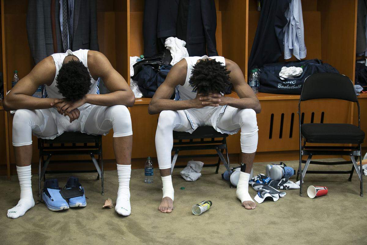 North Carolina’s Sterling Manley (21) and Leaky Black (1) sit dejected in the Tar Heels’ locker room following their 97-80 loss to Auburn in the Sweet 16 on Friday, March 29, 2019 at the Sprint Center in Kansas City, Missouri.