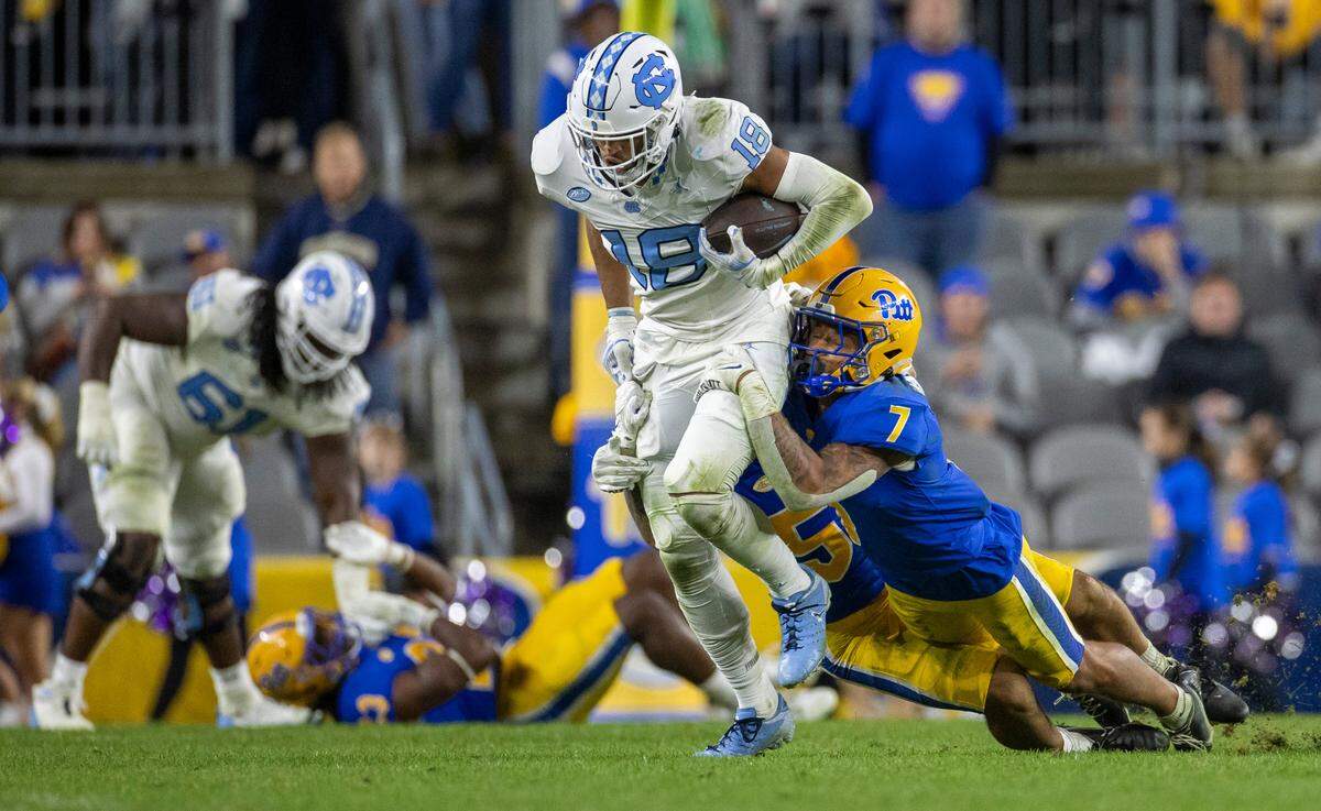 Pitt’s Javon McIntyre (7) works to stop North Carolina’s Bryson Nesbit (18) as he picks up 15-yards on a pass completion from quarterback Drake Maye in the fourth quarter on Saturday, September 23, 2023 at Acrisure Stadium in Pittsburgh, Pa.
