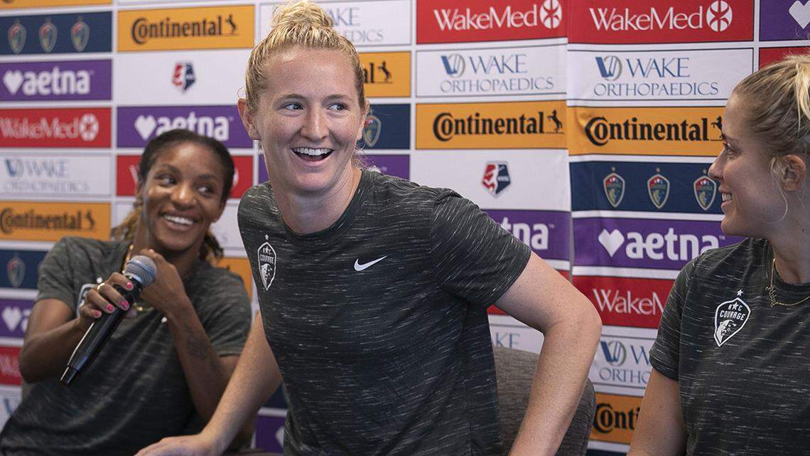 World Cup Champion and NC Courage team member Samantha Mewis, center, reacts during a press conference with fellow teammates Crystal Dunn, left and Abby Dahlkemper on Wednesday, July 17, 2019 in Cary, N.C. The three along with Jessica McDonald took questions from the media about their World Cup experience and their return to complete the season with the NC Courage.