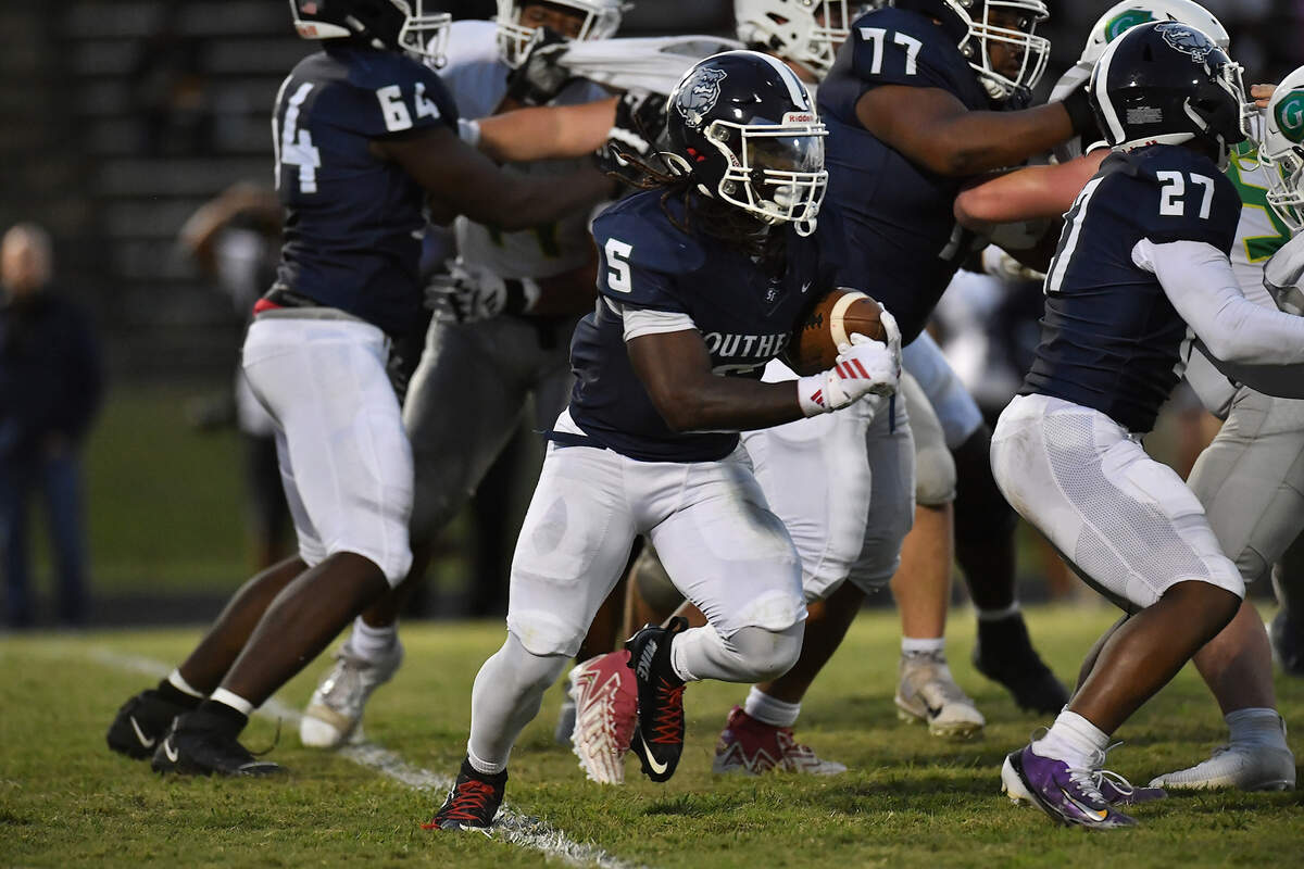 Southeast Raleigh running back Christian Freeman (5)  runs for yardage against Cardinal Gibbs during the first half. The Southeast Raleigh Bulldogs and the Cardinal Gibbons Crusaders met in a non-conference football game in Raleigh, N.C. September 12, 2025