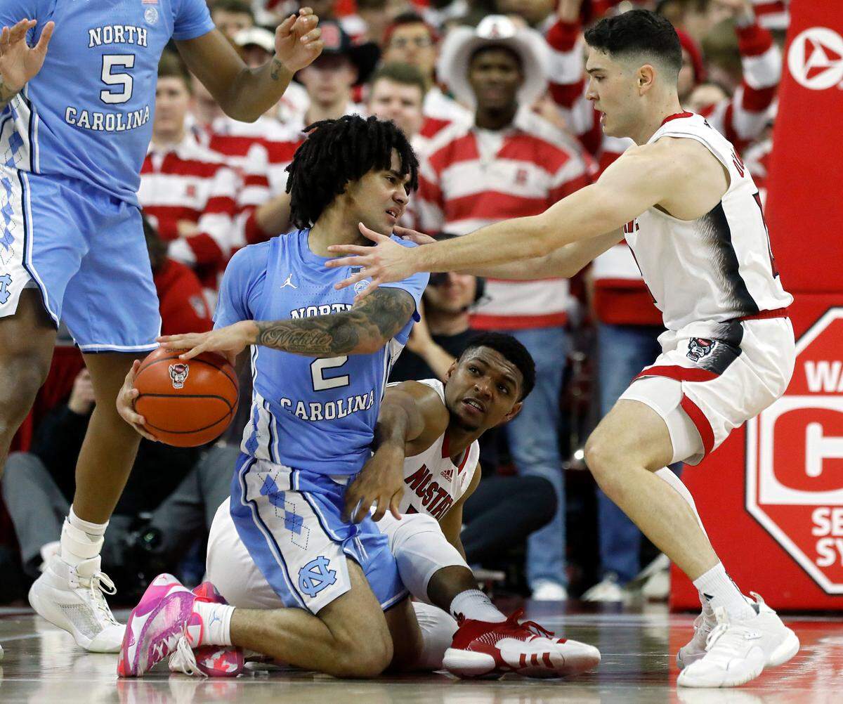 N.C. State’s Casey Morsell and Michael O’Connell pressure North Carolina’s Elliot Cadeau during the second half of the Tar Heels’ 67-54 win at PNC Arena on Wednesday, Jan. 10, 2024, in Raleigh, N.C.