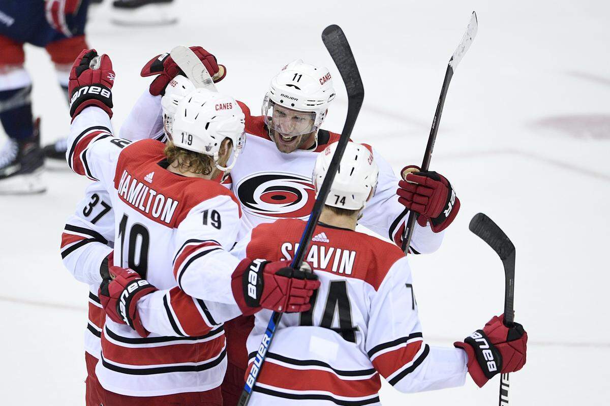 Carolina Hurricanes center Jordan Staal (11) celebrates his goal with defensemen Dougie Hamilton (19) and Jaccob Slavin (74) and right wing Andrei Svechnikov (37) during the third period of Game 2 of an NHL hockey first-round playoff series against the Washington Capitals, Saturday, April 13, 2019, in Washington.