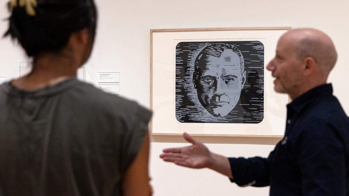 Julianne Miao, curatorial assistant, and Marshall Price, chief curator, stand next to a piece of artwork titled “Cosmic Consciousness,” one piece included in an exhibit curated by A.I. at the Nasher Museum of Art at Duke University on Thursday, Sept. 14, 2023, in Durham, N.C.