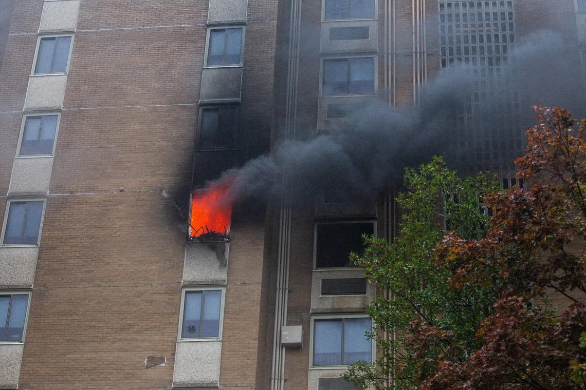 Smoke and flames pour out of a ninth-floor window at Glenwood Towers, a senior-living complex in downtown Raleigh, Friday, Oct. 26, 2018.