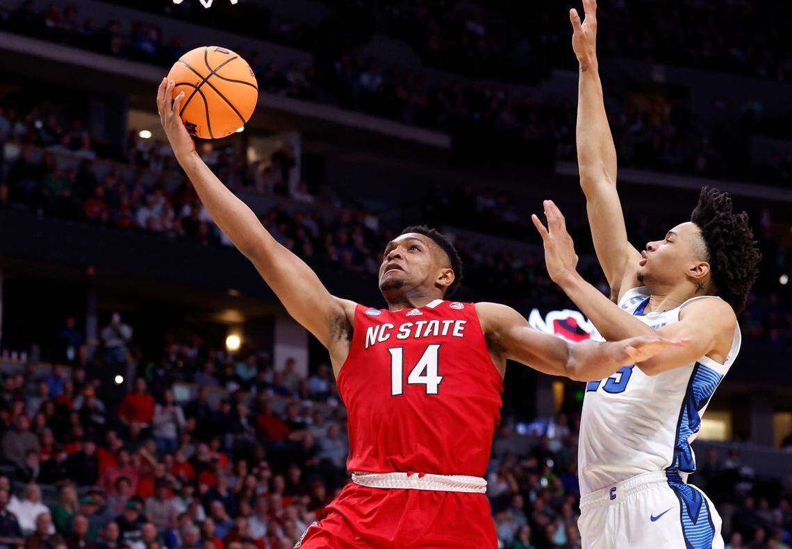 N.C. State’s Casey Morsell (14) drives to the basket past Creighton’s Trey Alexander (23) during the first half of N.C. State’s game against Creighton in the first round of the NCAA Tournament at Ball Arena in Denver, Colo., Friday, March 17, 2023.