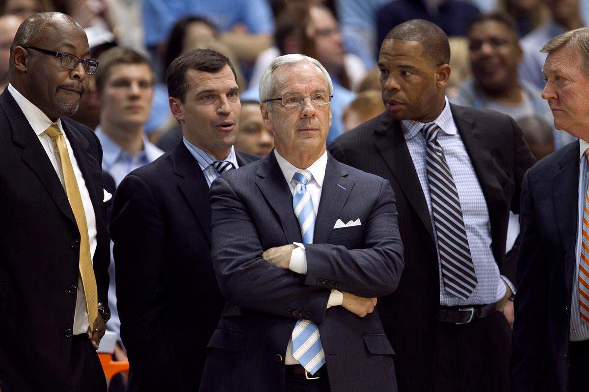 UNC coach Roy Williams is surrounded by his assistants (l-r) Steve Robinson, C.B. McGrath, Hubert Davis, and Joe Holladay as they survey the offensive set for the final play of regulation with :01 to play against Virginia Tech on Saturday February 2, 2013 at the Smith Center in Chapel Hill, N.C.