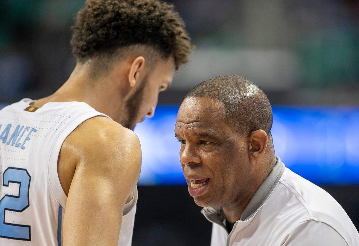 North Carolina coach Hubert Davis confers with Pete Nance (32) in the second half against Boston College in the second round of the ACC Tournament on Wednesday, March 8, 2023 at the Greensboro Coliseum in Greensboro, N.C.