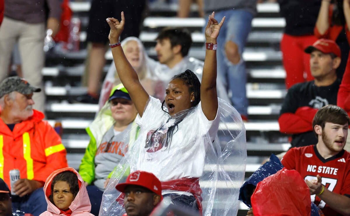 Fans cheer on the Wolfpack during the second half of N.C. State’s 24-21 victory over Virginia at Scott Stadium in Charlottesville, Va., Friday, Sept. 22, 2023.