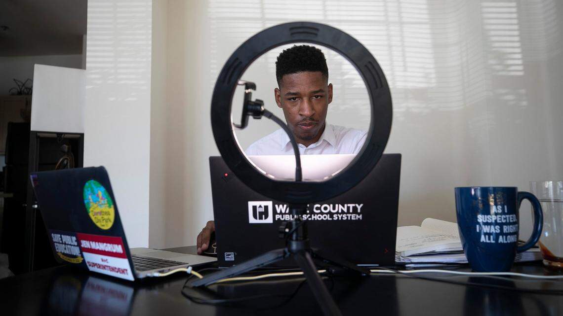 Enloe High School teacher Tyler Swanson works with his freshman English class remotely from his dining room table in his apartment on Monday, August 17, 2020 in Cary, N.C. Swanson is in his third year of teaching, and was spending most of the first day of classes orienting himself and his students to remote learning due to the COVID-19 virus.  