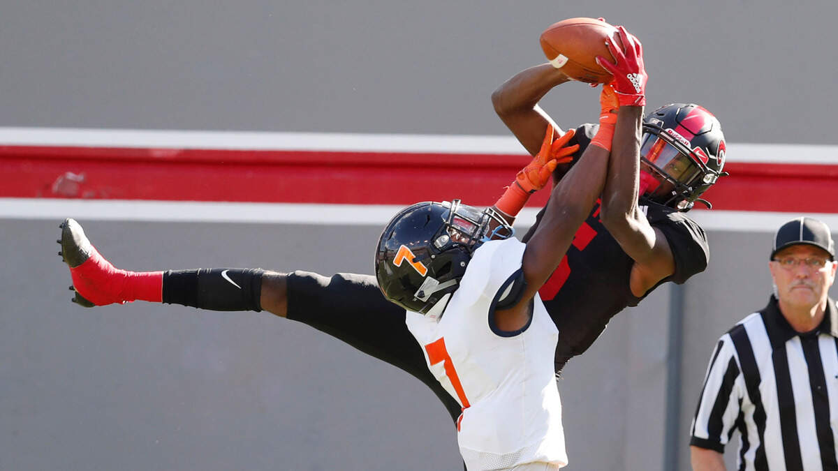 Rolesville’s Noah Rogers (5) makes a13-yard touchdown reception as Vance’s Nathaniel Spindle (7) defends during the first half of Rolesville High School’s game against Vance High School in the NCHSAA 4AA state championship at Carter-Finley Stadium in Raleigh, N.C., Saturday, May 8, 2021.