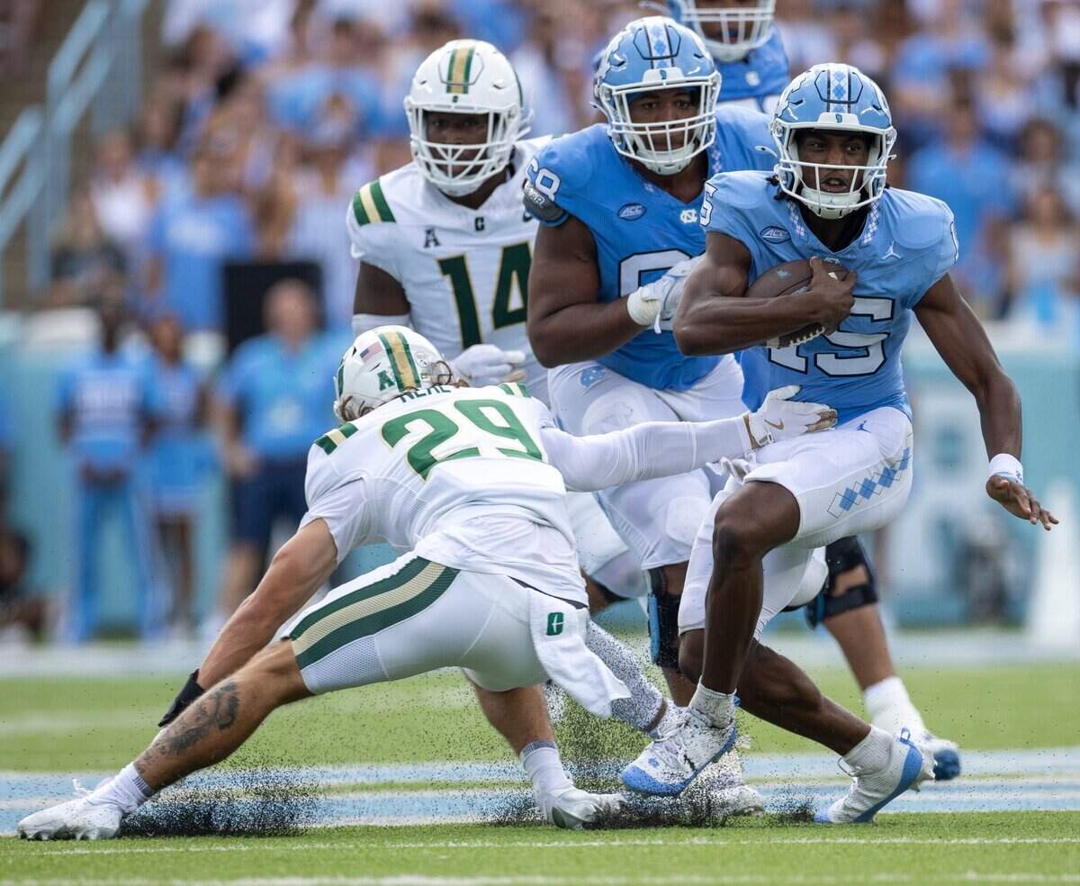 North Carolina quarterback Conner Harrell (15) breaks away from Charlotte defensive back Maguire Neal (29) for a 15-yard gain in the second quarter on Saturday, September 7, 2024 at Kenan Stadium in Chapel Hill, N.C.