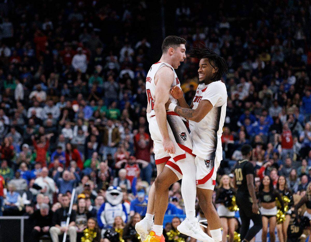 N.C. State’s Michael O’Connell and Jayden Taylor celebrate following the Wolfpack’s 79-73 overtime win against Oakland in the second round of the NCAA Tournament on Saturday, March 23, 2024, at PPG Paints Arena in Pittsburgh, Pa.