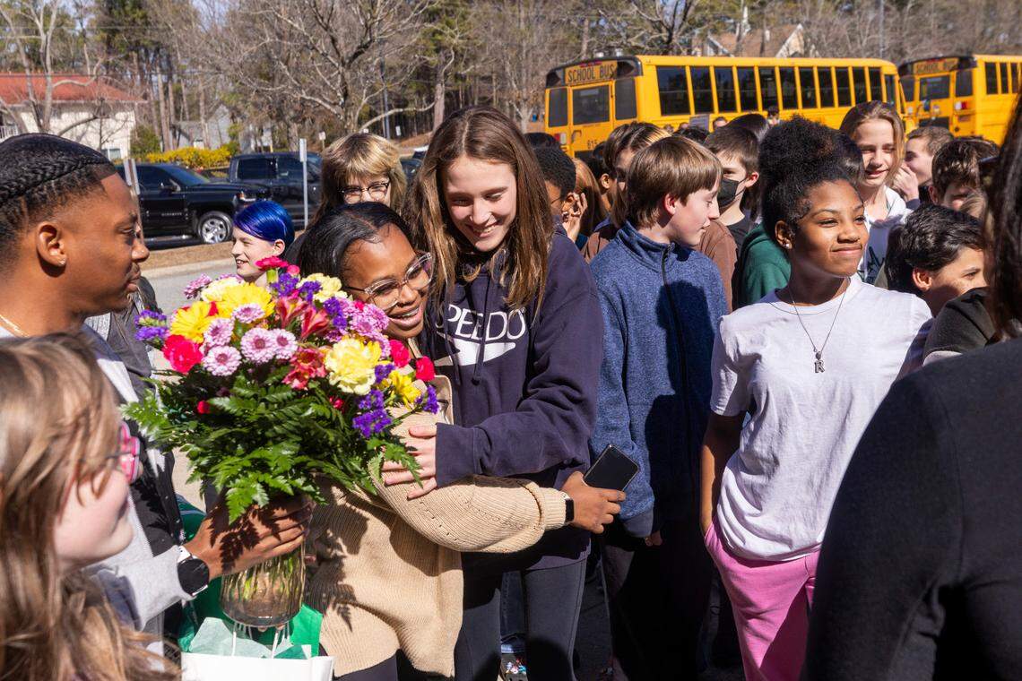 School bus driver Deona Washington, center left, receives a hero’s welcome at Brogden Middle School in Durham on Monday, Feb. 20, 2024. Washington safely evacuated all 28 of her students from a school bus engulfed in flames on Friday.