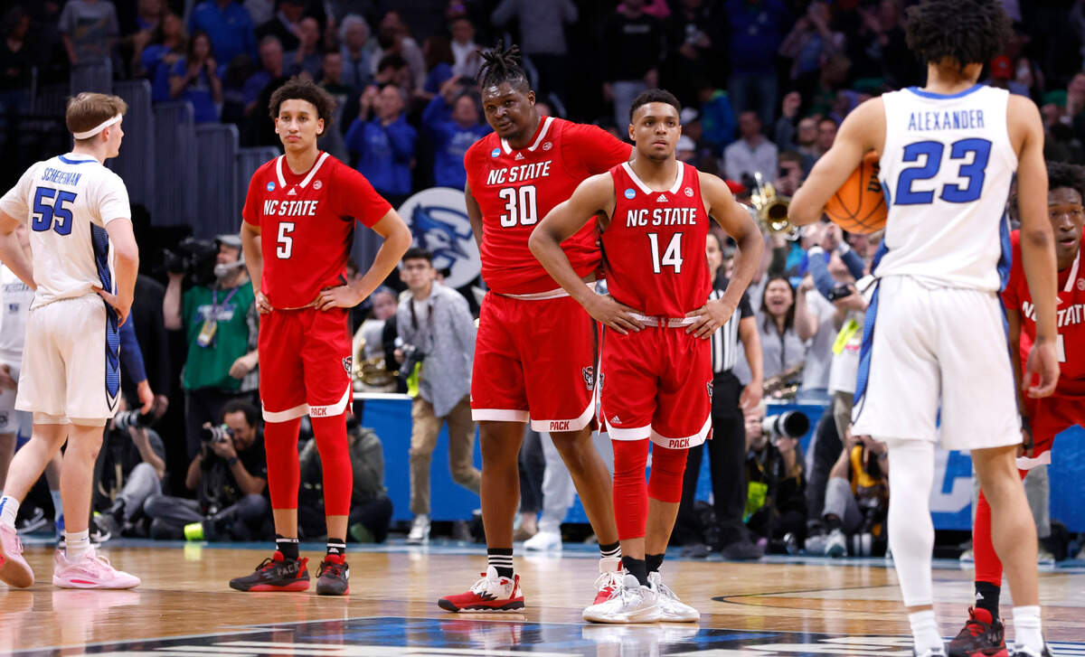 From left, N.C. State’s Jack Clark (5), D.J. Burns Jr. (30) and Casey Morsell (14) watch as time runs out in Creighton’s 72-63 victory over N.C. State in the first round of the NCAA Tournament at Ball Arena in Denver, Colo., Friday, March 17, 2023.