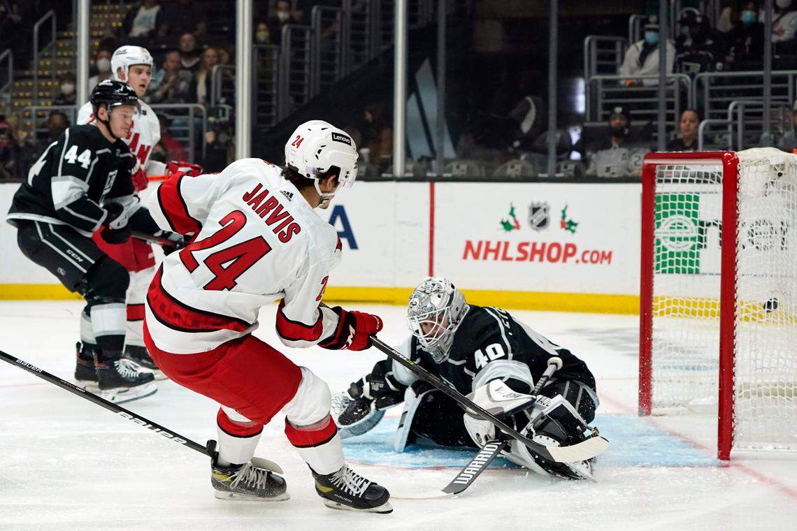 Carolina Hurricanes center Seth Jarvis (24) scores past Los Angeles Kings goaltender Cal Petersen during the first period of an NHL hockey game Saturday, Nov. 20, 2021, in Los Angeles. (AP Photo/Marcio Jose Sanchez)