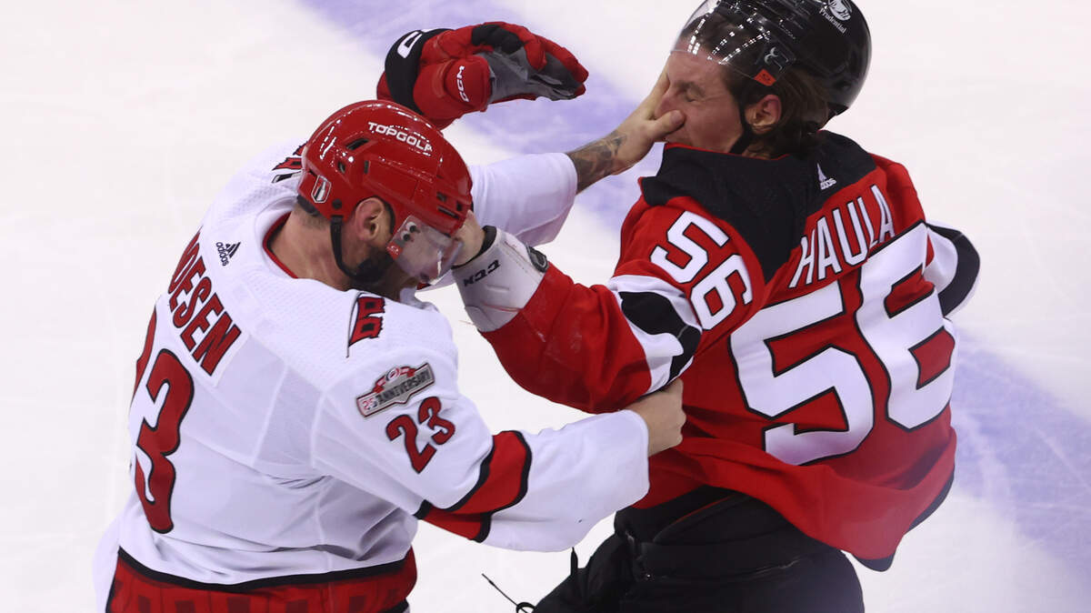 Carolina Hurricanes right wing Stefan Noesen (23) and New Jersey Devils left wing Erik Haula (56) fight during the third period in game three of the second round of the 2023 Stanley Cup Playoffs at Prudential Center.