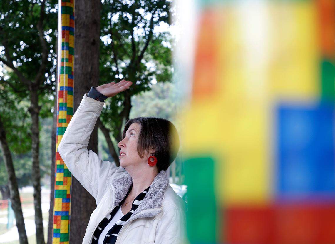 Emily Hardee, assistant principal at Brentwood Elementary School, stands in an outdoor walkway where colorful wrapping on poles covers chipped paint on Wednesday, Oct. 12, 2022, in Raleigh, N.C. Brentwood Elementary is one of seven schools that would undergo renovations in a $530.7 million bond referendum on the Nov. 8 ballot.