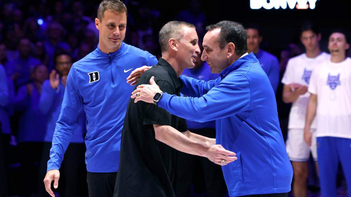 Former Duke head coach Mike Krzyzewski hugs Arizona State head coach Bobby Hurley as Duke head coach Jon Scheyer watches during a ceremony before Duke’s game against Arizona State in the Brotherhood Run Charity Game at Cameron Indoor Stadium in Durham, N.C., Sunday, Oct. 27, 2024.