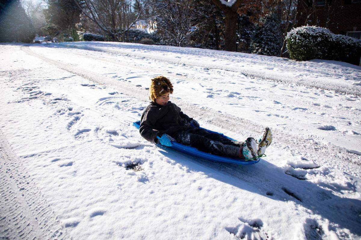 Jaan Ewing, 7, sleds down N. Boundary St. in Chapel Hill, N.C. on Saturday, Jan. 22, 2022.