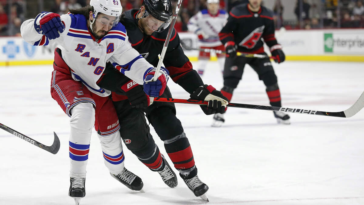 New York Rangers center Mika Zibanejad (93), of Sweden, and Carolina Hurricanes center Jordan Staal (11) skate for the puck during the first period of an NHL hockey game in Raleigh, N.C., Friday, Feb. 21, 2020. (AP Photo/Gerry Broome)
