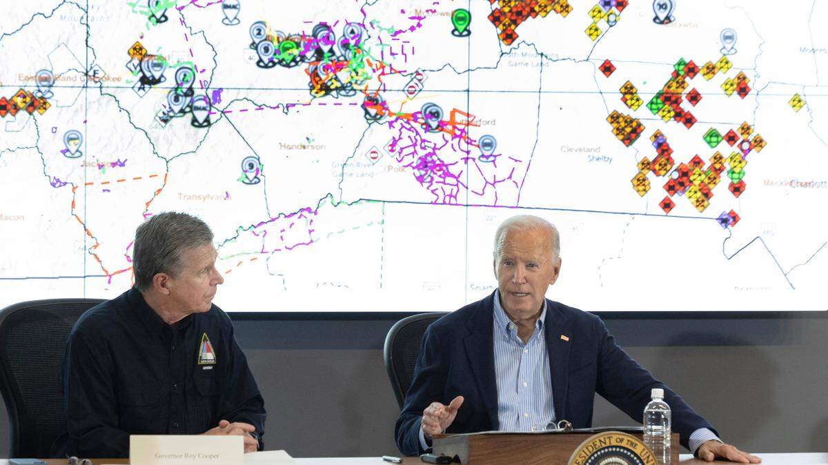President Joe Biden speaks while getting a briefing on the response to Hurricane Helene at the N.C. Emergency Operations Center in Raleigh, N.C., Wednesday, Oct. 2, 2024. N.C. Gov. Roy Cooper sits to the left.