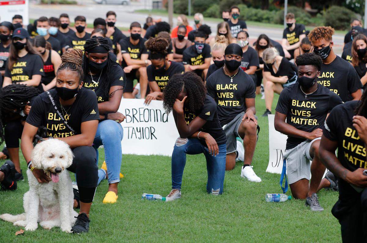 N.C. State athletes, coaches and staff kneel for 8:46, the time police kneeled on George Floyd, during a #PackUnited peaceful protest against racial and social injustice outside Holladay Hall on the campus of N.C. State Saturday, Sept. 12, 2020.