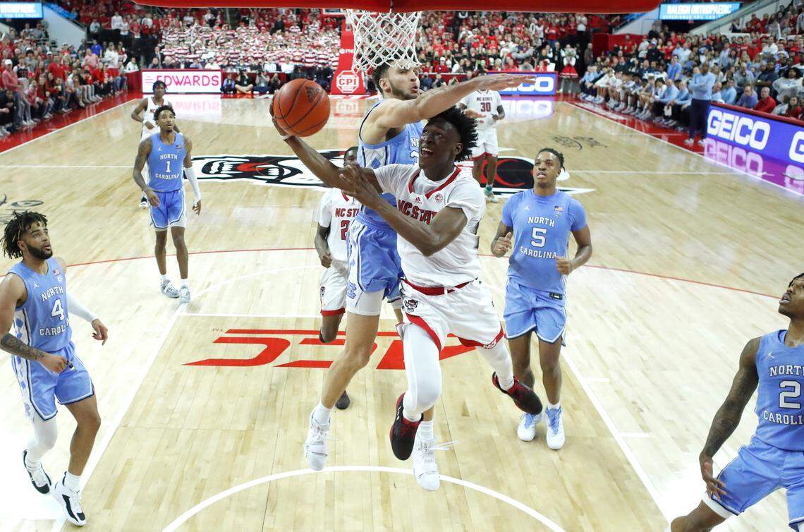 N.C. State’s Jarkel Joiner (1) shoots as North Carolina’s Pete Nance (32) defends during N.C. State’s 77-69 victory over UNC at PNC Arena in Raleigh, N.C., Sunday, Feb. 19, 2023.