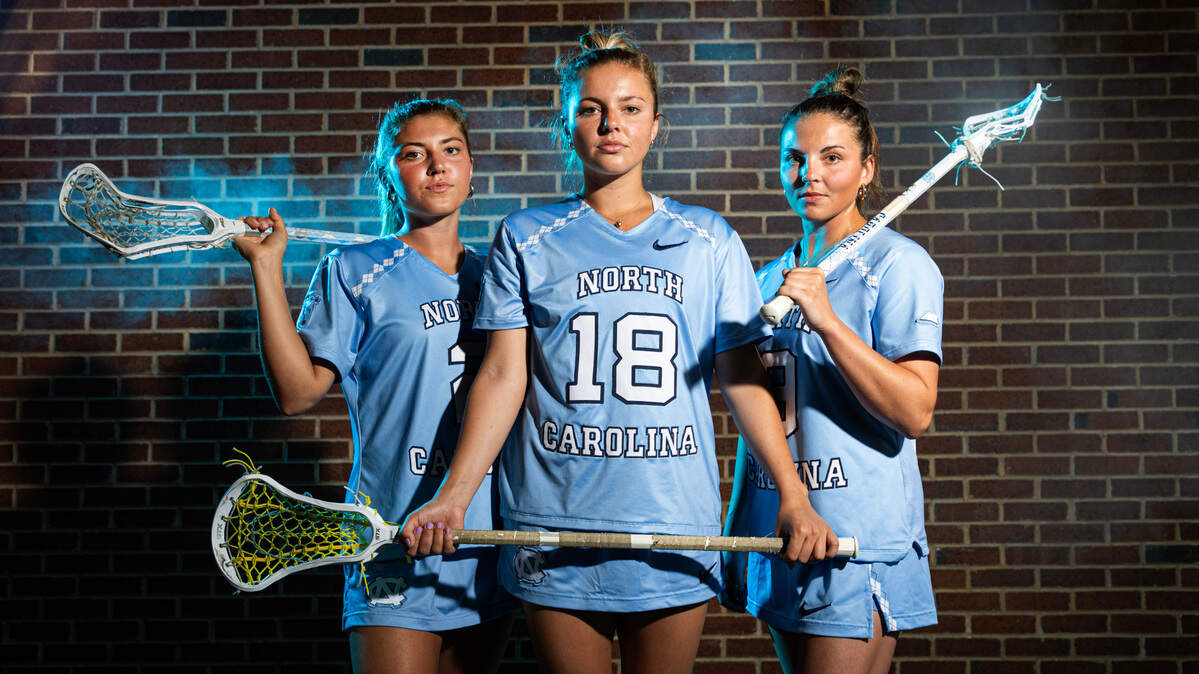 From left North Carolina lacrosse sisters Chloe Humphrey (2), Ashley Humphrey (18) and Nicole Humphrey (9) pose at Dorrance Field on the campus of UNC Friday, May 2, 2025.