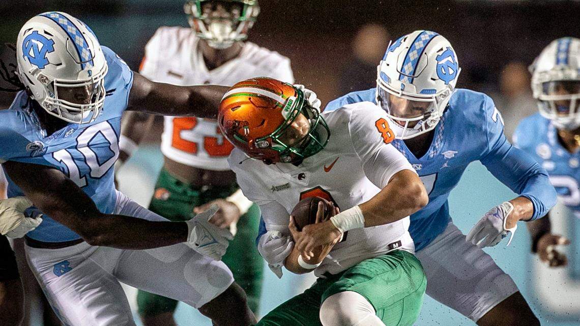 North Carolina’s Desmond Evans (10) and Noah Taylor (7) sack Florida A&M quarterback Jeremy Moussa (8) for a nine yard loss in the first quarter on Saturday, August 27, 2022 at Kenan Stadium in Chapel Hill, N.C.