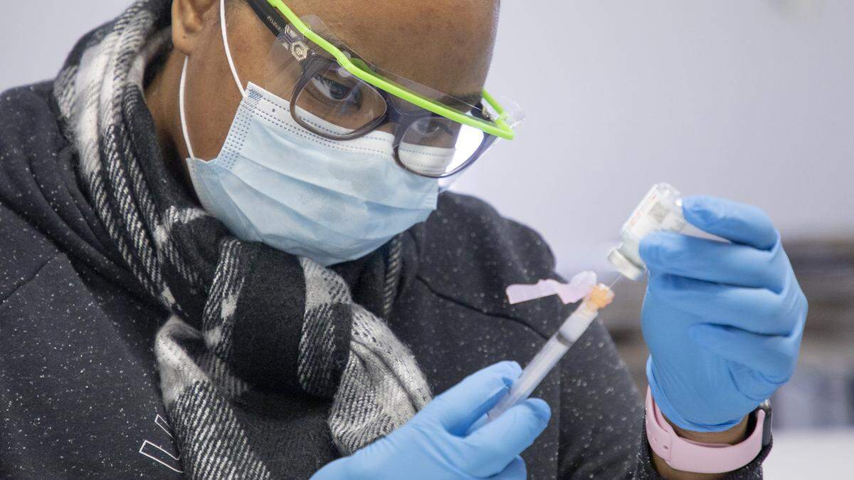 Registered nurse Kammira Holley prepares doses of the Moderna COVID-19 vaccine earlier this month at a UNC Health mobile clinic held outside Howell’s Chapel Church of Christ in Selma, NC.