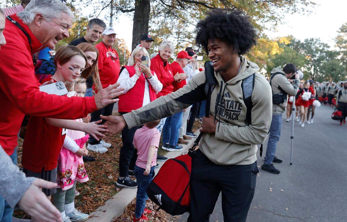 N.C. State’s KC Concepcion greets fans during the Walk of Champions before the game against Miami at Carter-Finley Stadium in Raleigh, N.C., Saturday, Nov. 4, 2023.