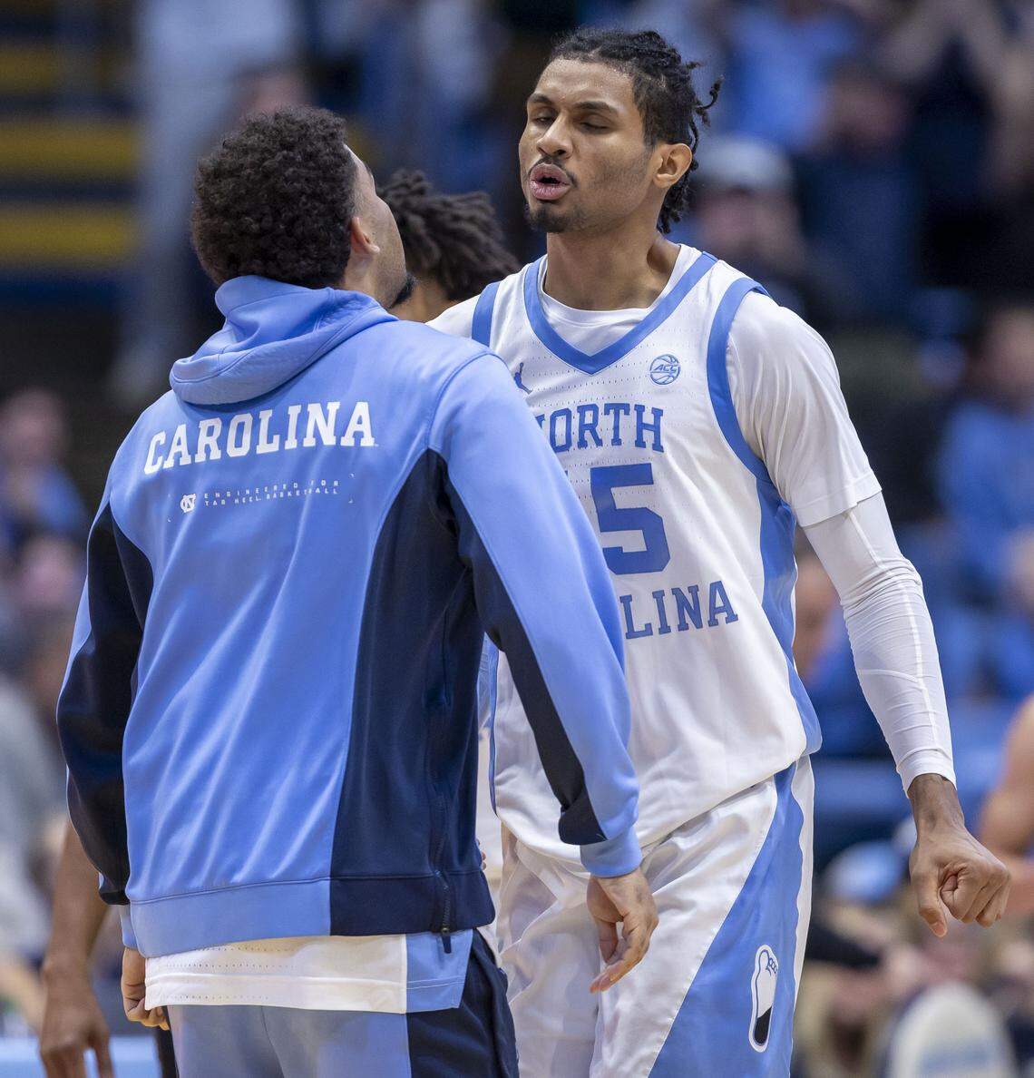 North Carolina forward Jarin Stevenson (15) chest bumps teammate Elijah Davis (6) after sinking a three-point basket in the second half against Georgetown on Sunday, December 7, 2025 at the Smith Center in Chapel Hill, N.C.