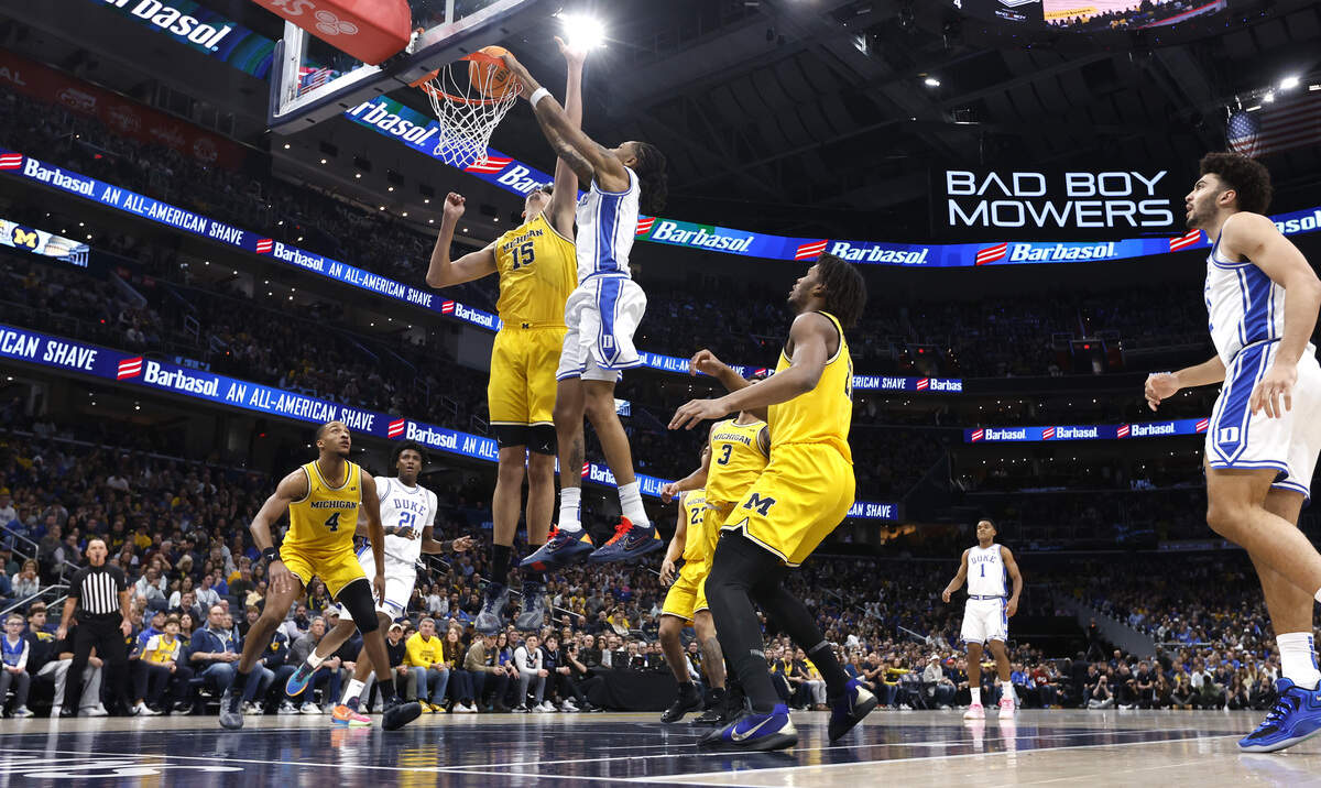 Duke’s Isaiah Evans (3) slams in two during Duke’s 68-63 victory over Michigan in the Capital Showcase at Capital One Arena in Washington, D.C., Saturday, Feb. 21, 2026.