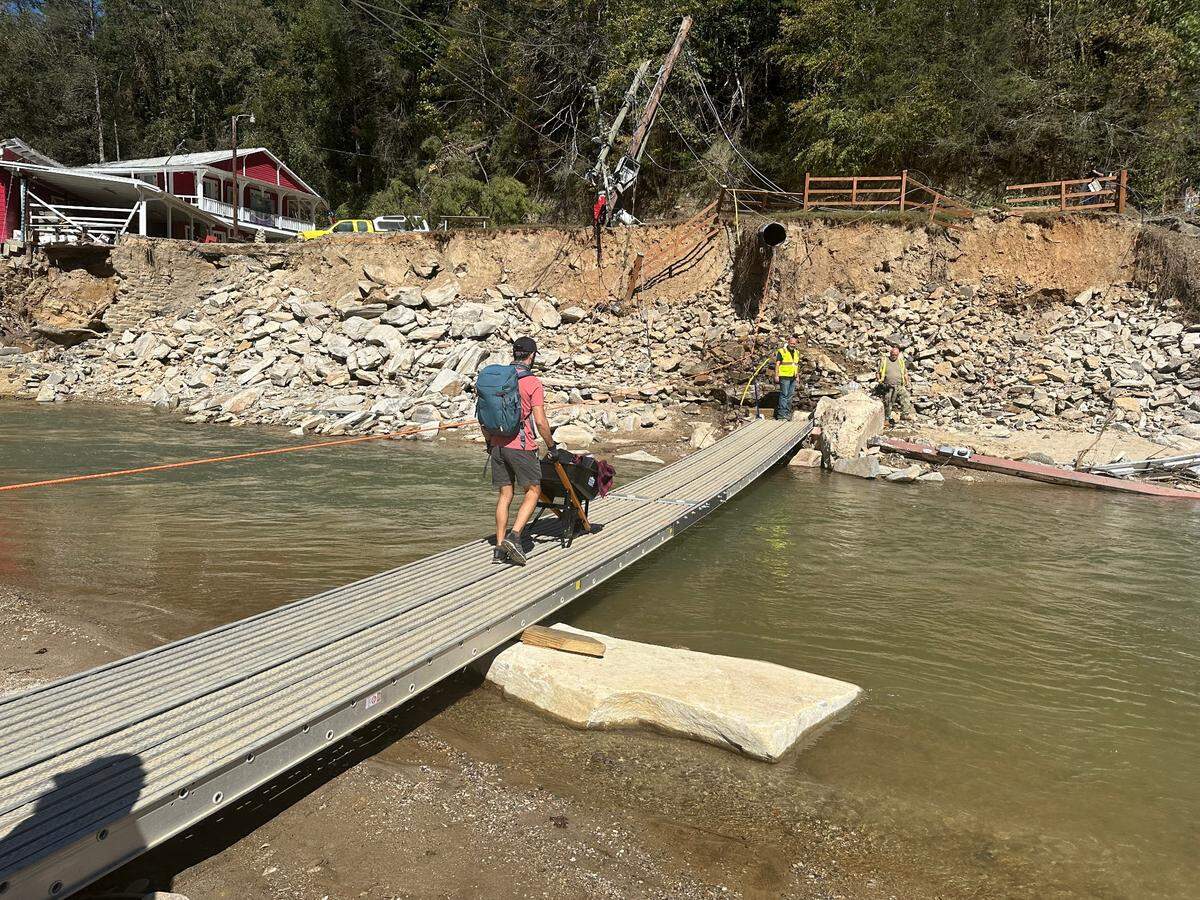 With the U.S. 64 bridge out, N.C. Department of Transportation engineers used scaffolding to make a footbridge over the Rocky Branch River in Bat Cave, North Carolina. Taken Thursday, Oct. 10, 2024.