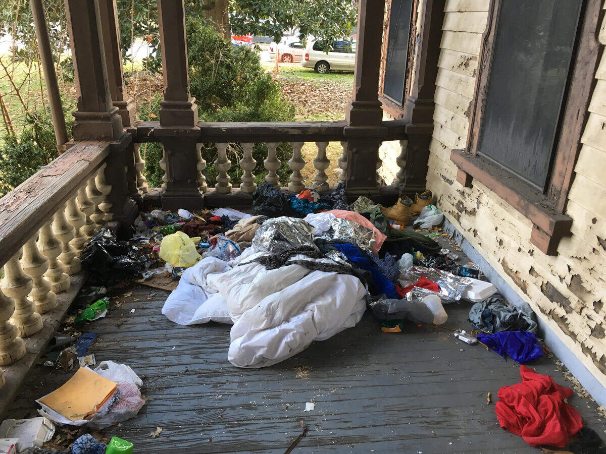 Garbage scattered on the front porch of the Andrews-Duncan House on North Blount Street in downtown Raleigh in 2019, which was completed in 1874 and is a Raleigh Historic Property.
