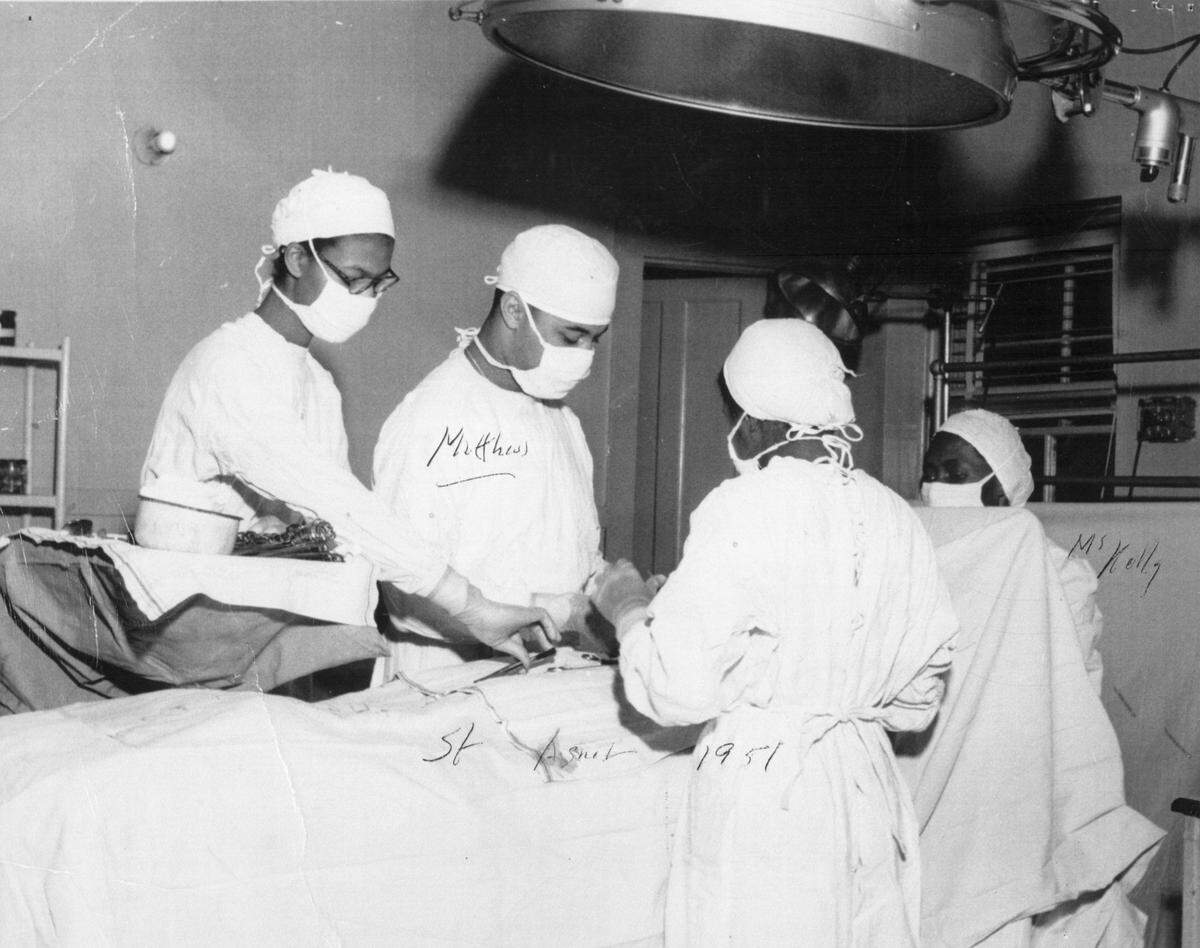 Surgery is performed at St. Agnes Hospital, on the campus of St. Augustines college, circa 1910.