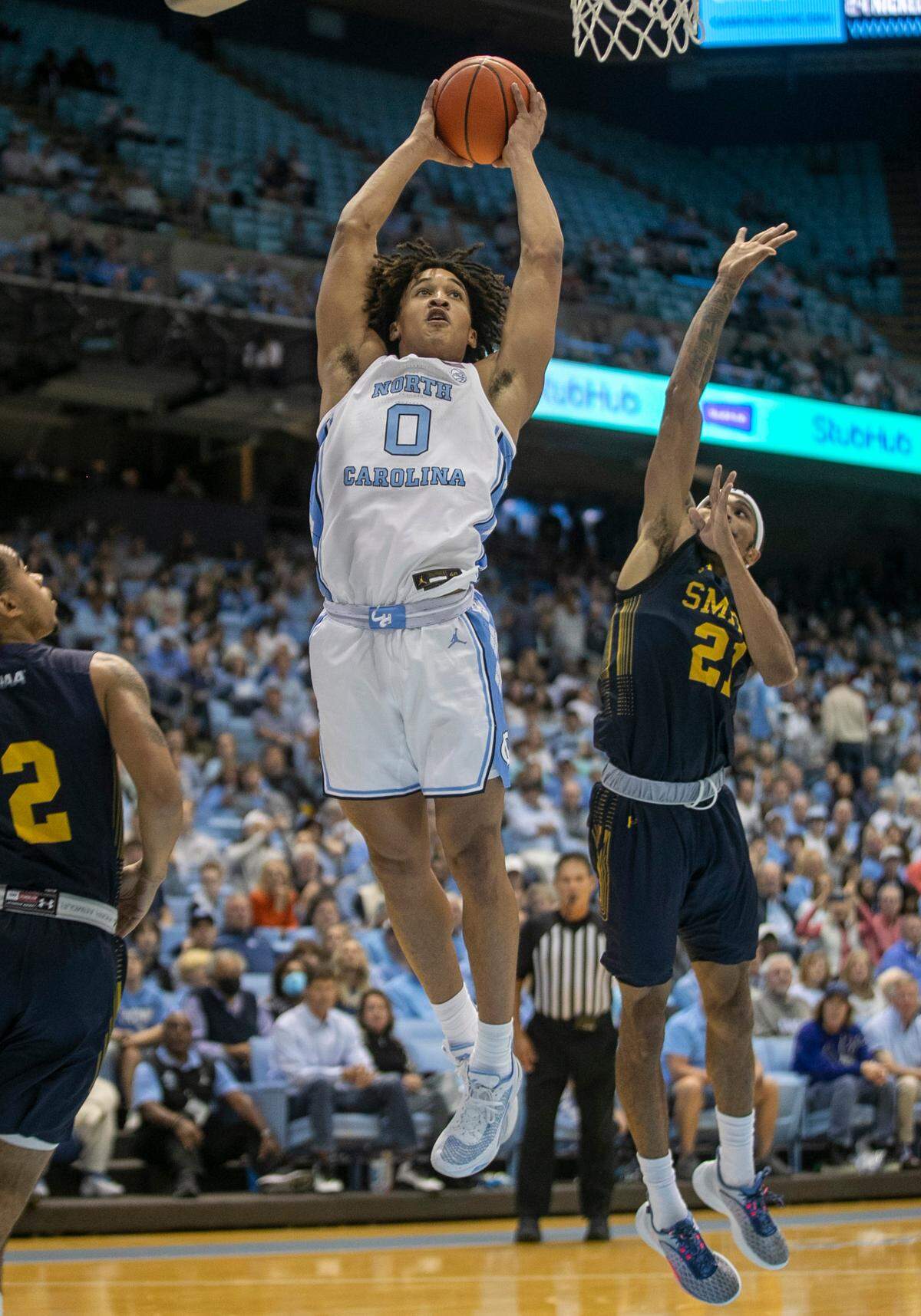 North Carolina’s Seth Trimble (0) drives to the basket for a dunk against Johnson C. Smith’s Nilous Hodge Jr. (21) in the first half during an exhibition game on Friday, October 28, 2022 at the Smith Center in Chapel Hill, N.