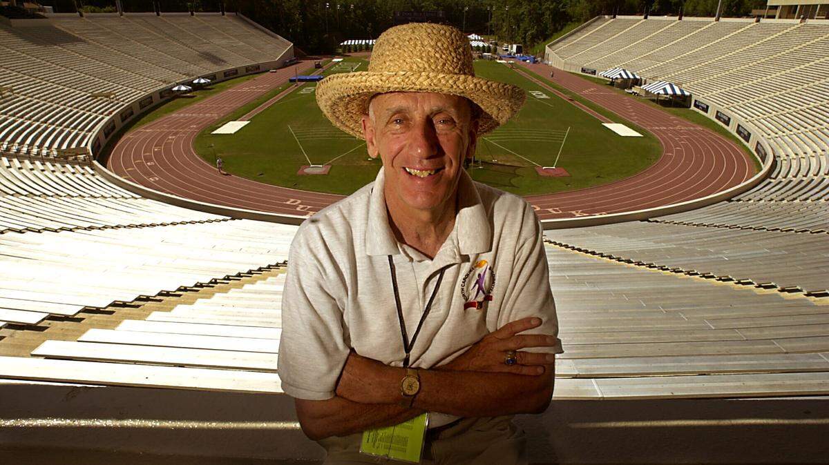 Al Buehler in his trademark straw hat sits above the track at Duke’s Wallace Wade Stadium in 2000, where he was a coach for 60 years. A legend in the track and field coaching community, Buehler, 92, died on Thursday, Jan. 5, 2023. CHUCK LIDDY PHOTO