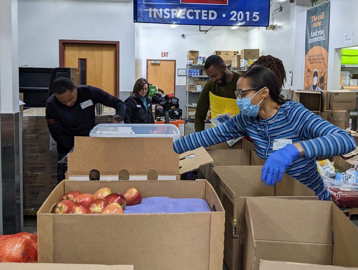 Volunteers packing and sorting food at an Inter-Faith Food Shuttle volunteer event.