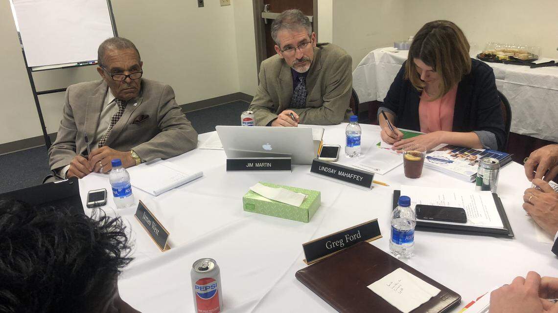 Seated left to right, Wake County Commissioner James West and Wake County school board members Jim Martin and Lindsay Mahaffey hear school staff members talk about funding needs at a joint meeting May 22, 2018 in Cary, N.C.