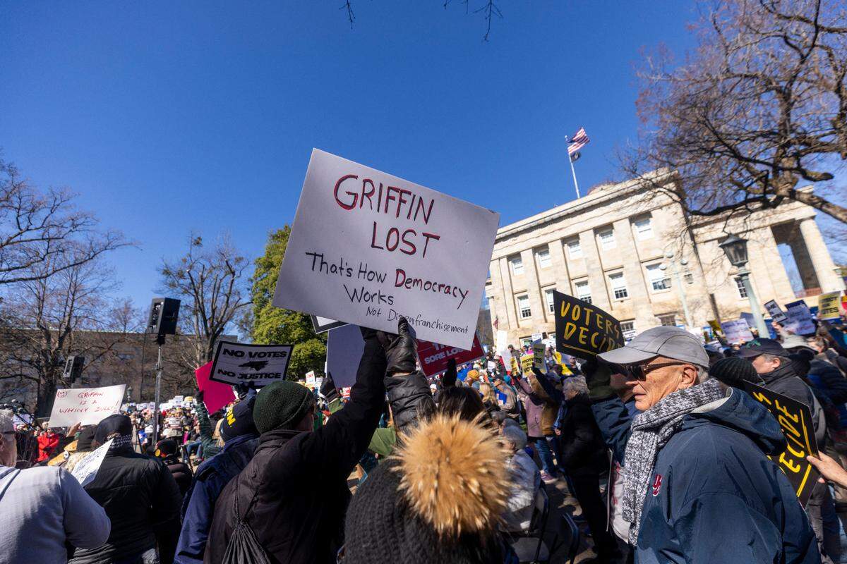 Hundreds of demonstrators rally at the North Carolina State Capitol on Monday. The rally, organized by Common Cause, protested Republican state Supreme Court candidate Jefferson Griffin’s challenge of 65,000 ballots in November’s election. He trails Democratic incumbent Justice Allison Riggs.