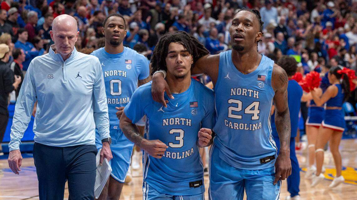 North Carolina forward Jae’Lyn Withers (24) consoles Elliot Cadeau (3) as they leave the court following their 92-89 loss to Kansas on Friday, November 8, 2024 at Allen Fieldhouse in Lawrence, Kansas. Cadeau missed the final shot of the game, a three-point attempt at the buzzer to secure the Jayhawks’ victory.
