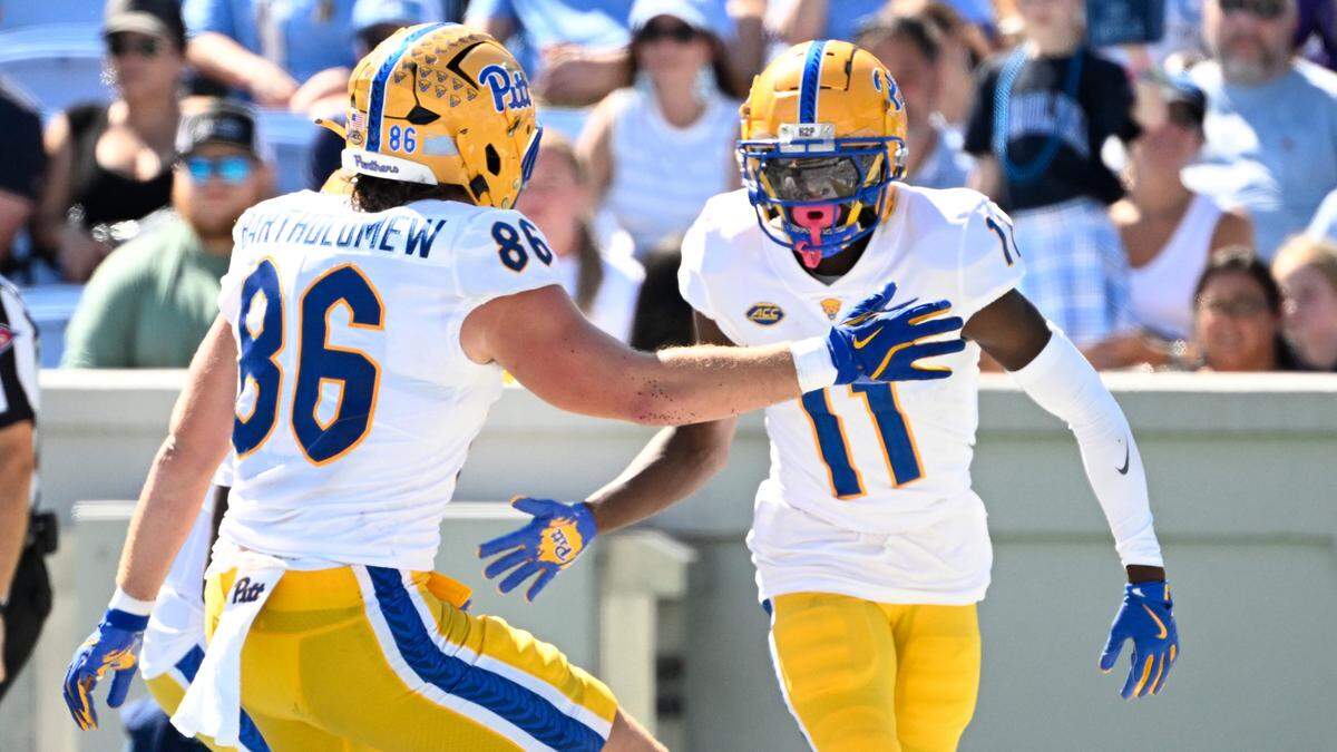 Pittsburgh Panthers wide reciever Censere Lee (11) celebrates with tight end Gavin Bartholomew (86) after scoring a touchdown in the second quarter at Kenan Memorial Stadium.